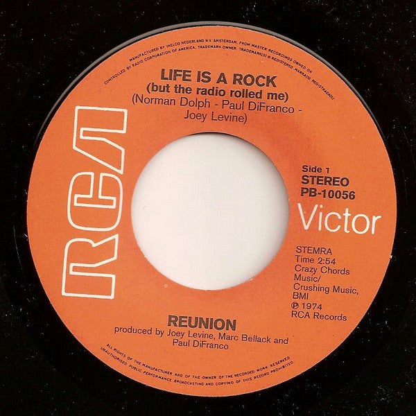 Reunion (3) : Life Is A Rock (But The Radio Rolled Me) (7", Single)